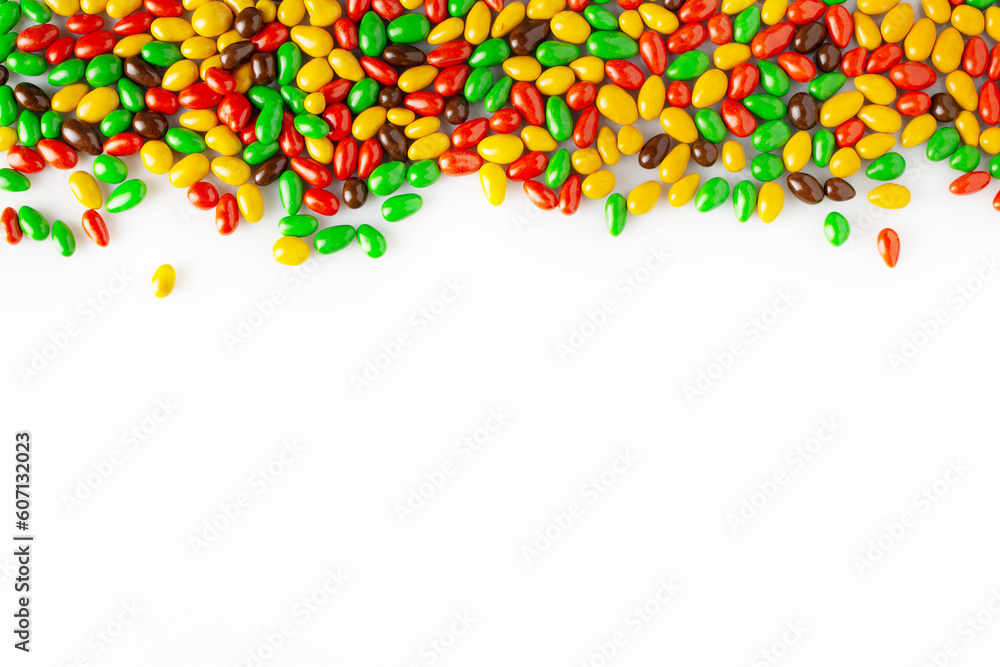 seeds in colored glaze are scattered on a white background, copy space seeds in colored glaze are scattered on a white background, copy space
