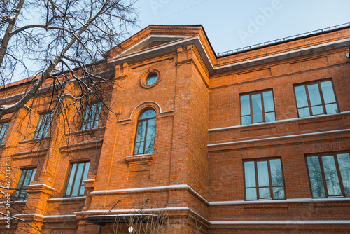 Windows in a red brick vintage building. Detail of old luxury house and home complex. Fragment of City Real estate property and architecture.