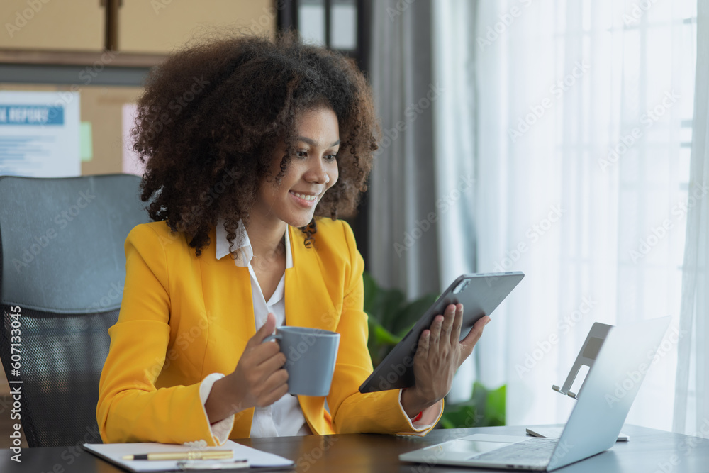 African American businesswoman working with tablet computer and finance marketing chart, Advisor showing plan of investment to clients at table office. Digital marketing online concept. African American businesswoman working with tablet computer and finance marketing chart, Advisor showing plan of investment to clients at table office. Digital marketing online concept.