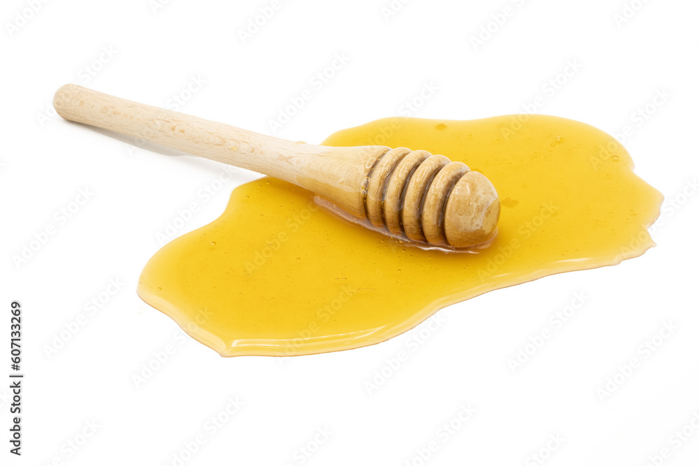Honey dipper on spilled honey isolated on white background Honey dipper on spilled honey isolated on white background