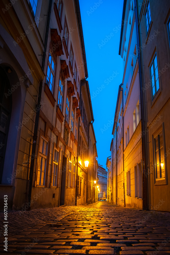 Romantic narrow street at Lesser town, Prague. Evening and street lamps on.