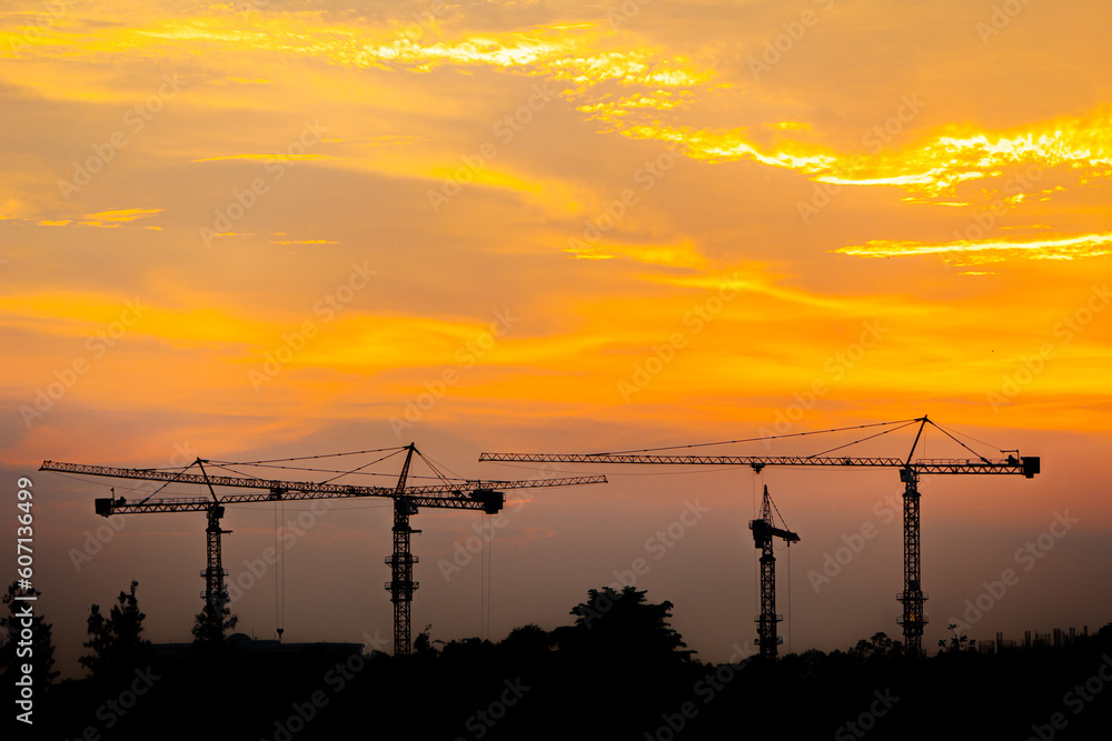 Crane. Crane for lifting things in construction against sunset sky atmosphere. communities and large industrial construction zones.