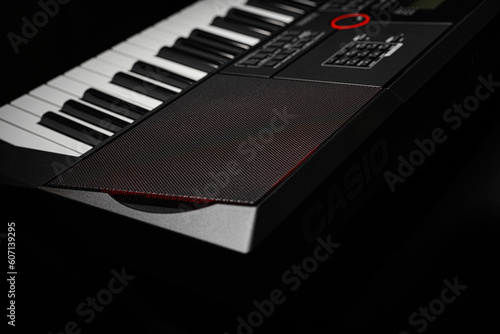 Keyboard synthesizer on a dark background. Electric piano close-up.