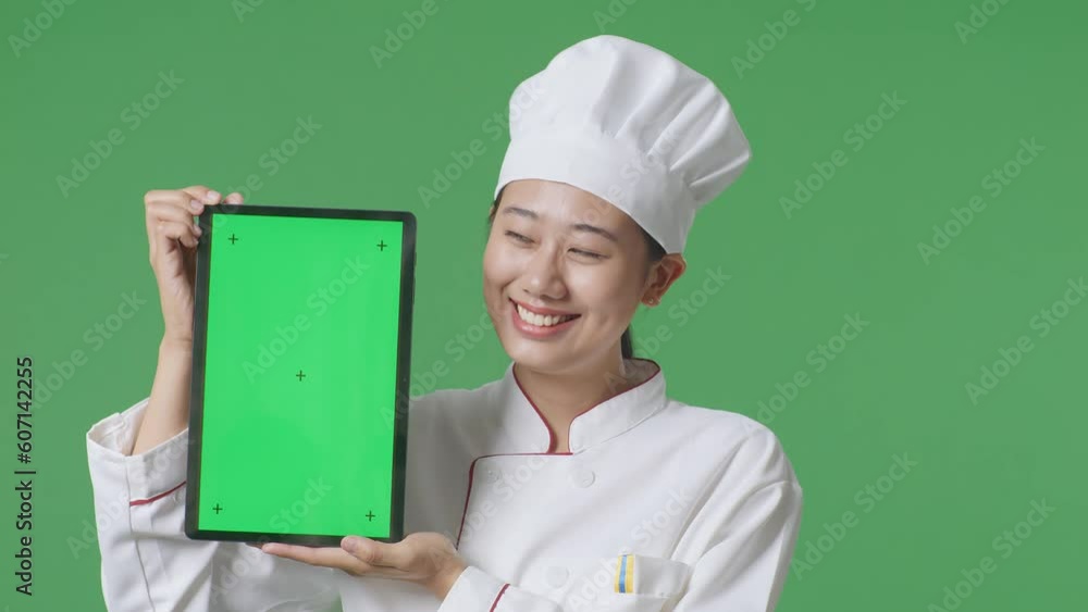 Close Up Of Asian Woman Chef Smiling And Showing Tongs And Ladle To Camera While Standing In The Green Screen Background Studio
Close Up Of Asian Woman Chef Smiling And Showing Tongs And Ladle To Camera While Standing In The Green Screen Background Studio