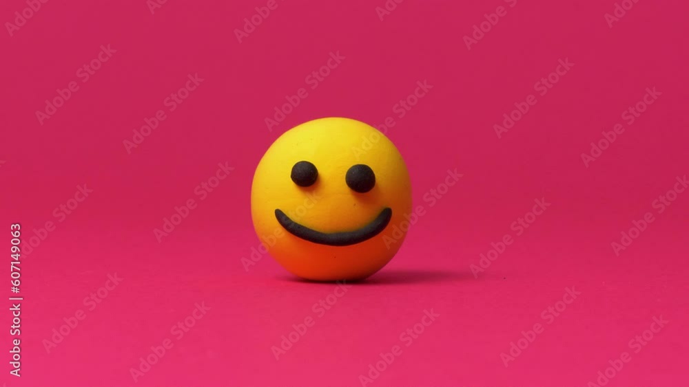 Happy smiley emoticon on red background Happy smiley emoticon on red background