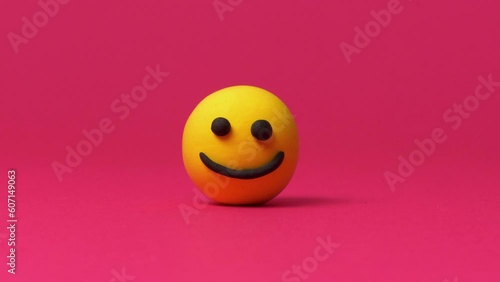 Happy smiley emoticon on red background photo