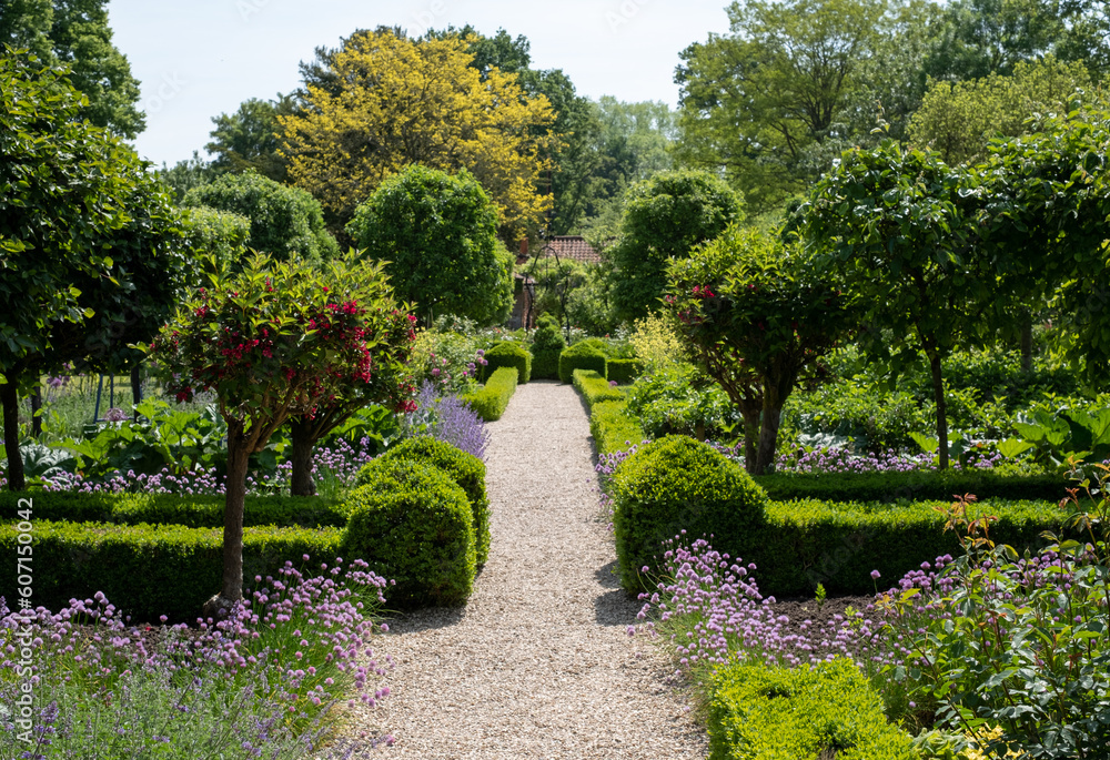 Flower borders in a landscaped garden in Hartley Wintney, Hampshire, UK