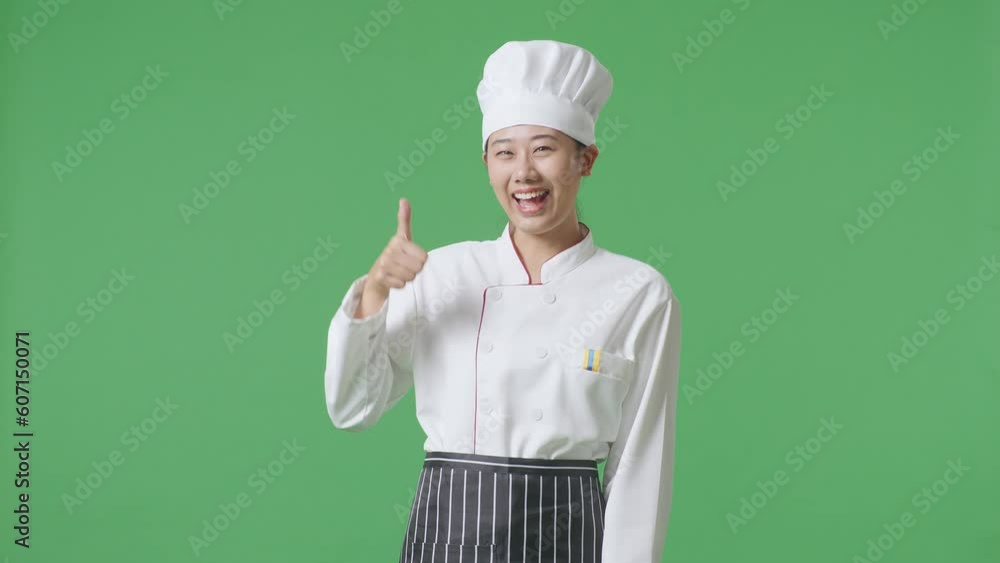 Asian Woman Chef Smiling And Showing Thumbs Up Gesture To Camera While Standing In The Green Screen Background Studio
Asian Woman Chef Smiling And Showing Thumbs Up Gesture To Camera While Standing In The Green Screen Background Studio