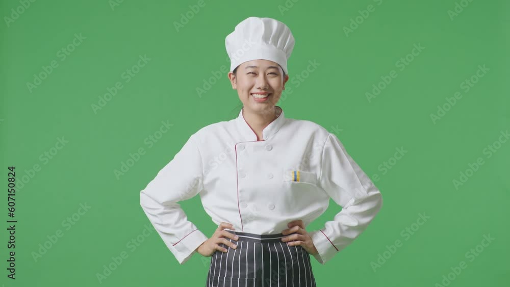 Asian Woman Chef With Arms Akimbo Looking At Camera And Smiling While Standing In The Green Screen Background Studio
Asian Woman Chef With Arms Akimbo Looking At Camera And Smiling While Standing In The Green Screen Background Studio
