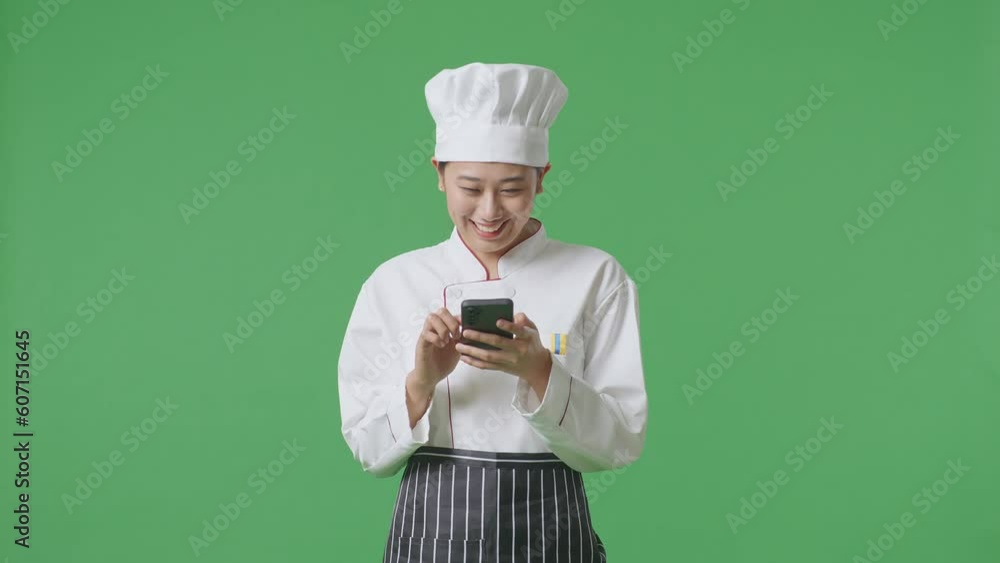 Asian Woman Chef Using Smartphone And Pointing To Side While Standing In The Green Screen Background Studio
Asian Woman Chef Using Smartphone And Pointing To Side While Standing In The Green Screen Background Studio