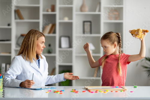 Photos Disobedient bad tempered little girl throwing tantrum at appointment meeting wit