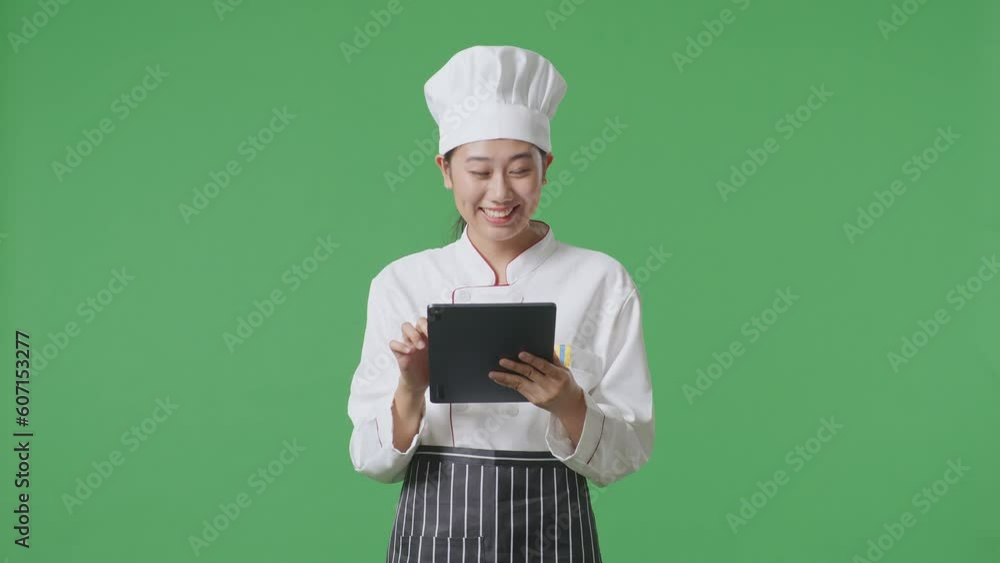 Asian Woman Chef Smiling And Pointing To Tablet In Her Hand While Standing In The Green Screen Background Studio
Asian Woman Chef Smiling And Pointing To Tablet In Her Hand While Standing In The Green Screen Background Studio