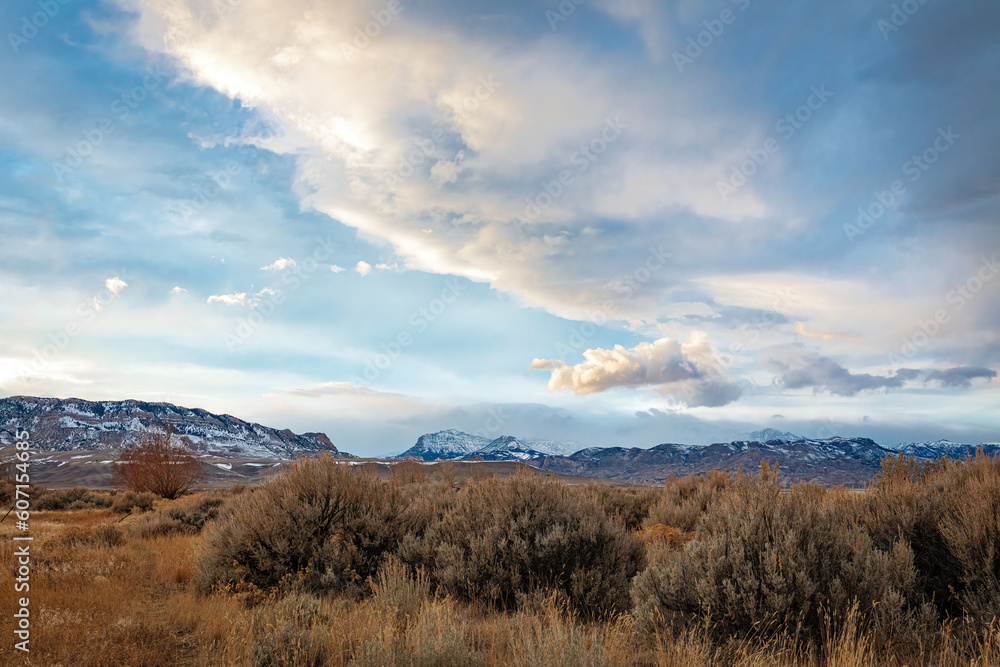 Cloudscape of the western desert environment of northwest Wyoming in winter with sagebrush in the foreground