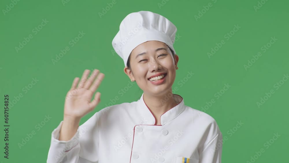 Close Up Of Asian Woman Chef Smiling, Waving Hand, And Saying Bye While Standing In The Green Screen Background Studio
Close Up Of Asian Woman Chef Smiling, Waving Hand, And Saying Bye While Standing In The Green Screen Background Studio