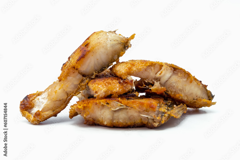 Pieces of fried fish on a white background. Pieces of fried fish on a white background.