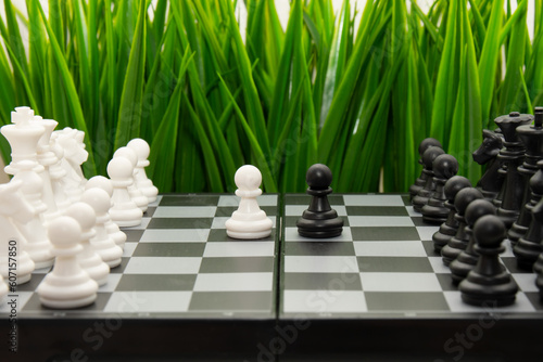 chess game. Black and white chess pawn on the background of a chessboard.The concept of confrontation and leadership