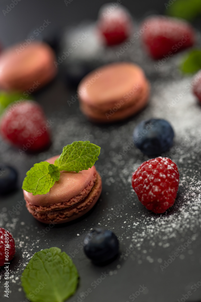 macaroons of different colors on a black background macaroons of different colors on a black background
