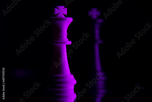 White and black chess king. The dark side of personality. Photography in the dark