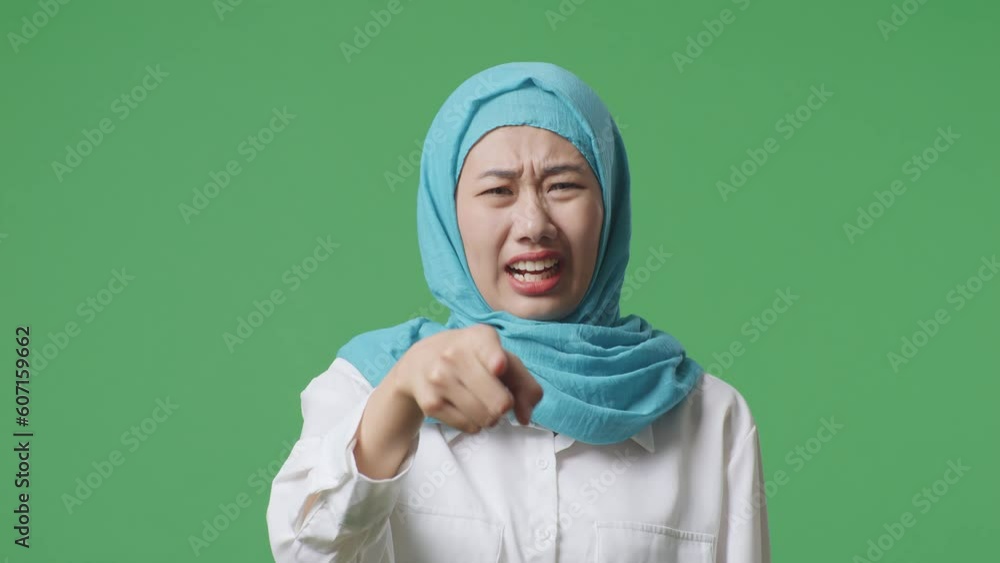 Close Up Of Asian Muslim Woman Shouting At Camera While Standing In The Green Screen Background Studio
Close Up Of Asian Muslim Woman Shouting At Camera While Standing In The Green Screen Background Studio