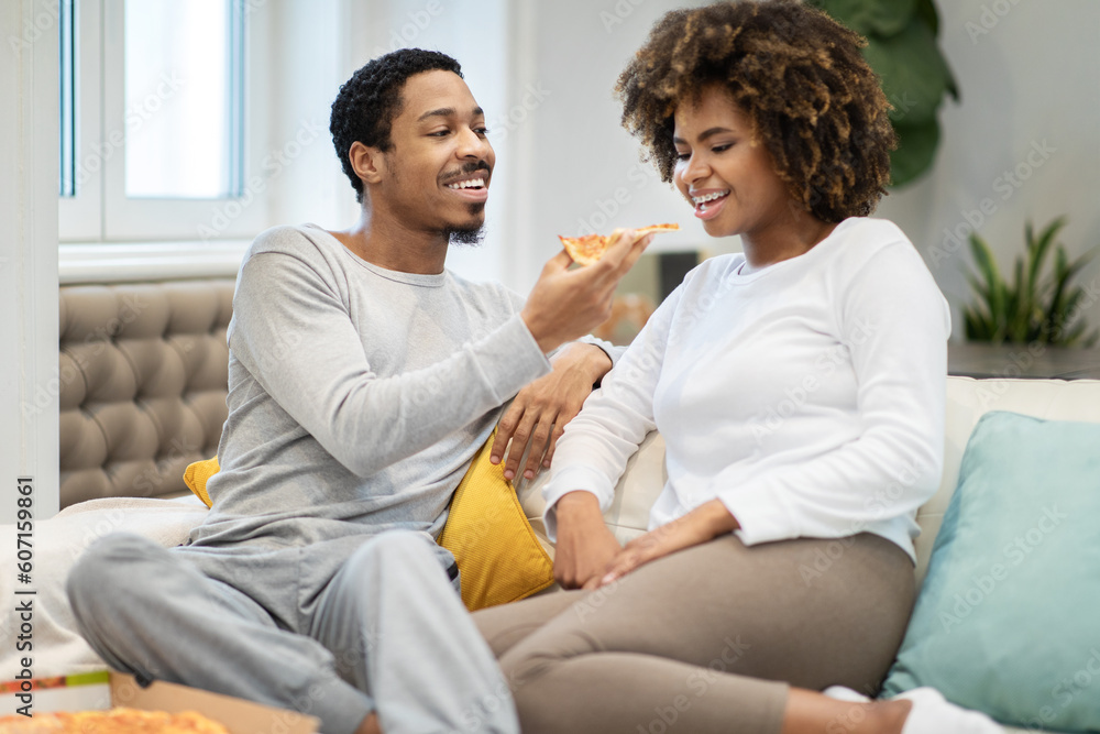 Loving black guy husband feeding his girlfriend, eating pizza Loving black guy husband feeding his girlfriend, eating pizza