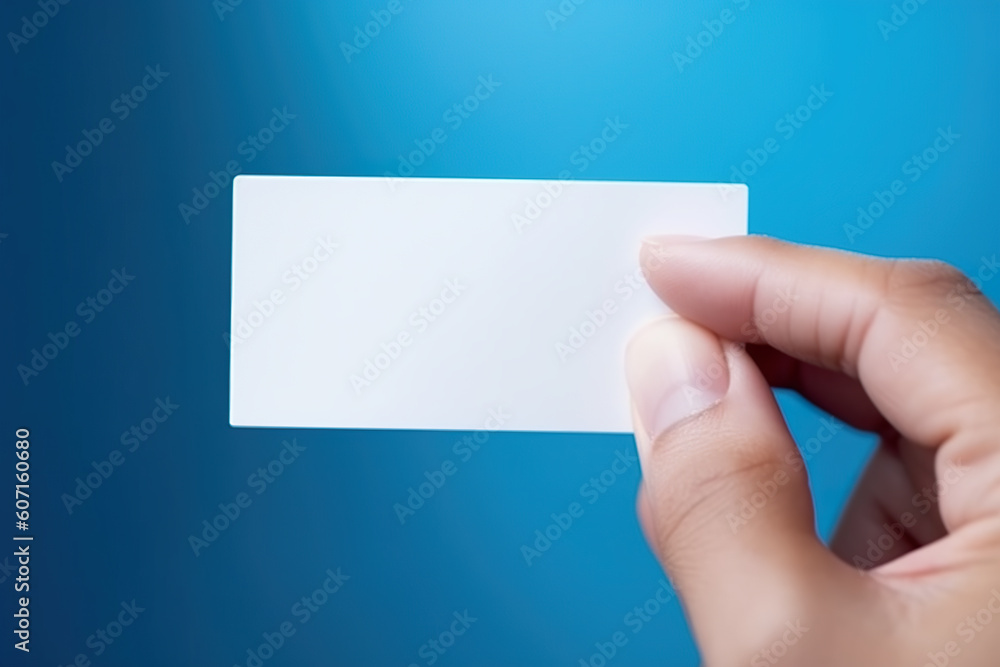 A hand holding a business card against a blue background. Generative AI. A hand holding a business card against a blue background. Generative AI.