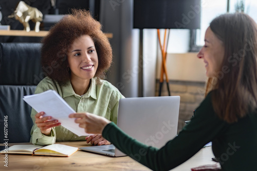 Caucasian female person having a job interview with a African American woman recruiter. Recruitment manager talking, hiring for job new employee sitting in office photo