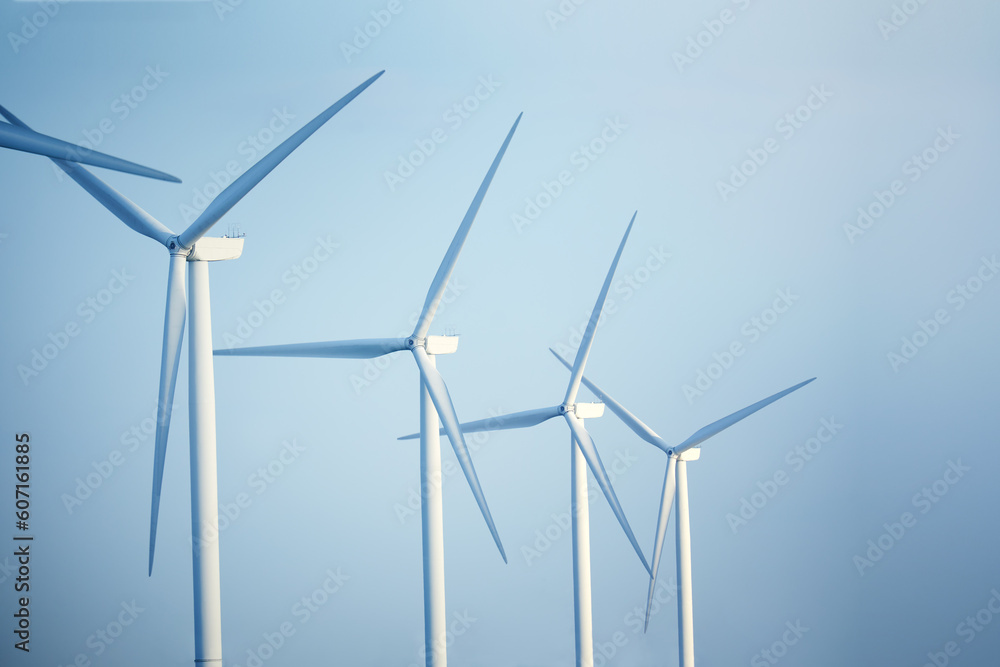 Close-up wind turbines against blue sky Green ecological power energy generation Close-up wind turbines against blue sky Green ecological power energy generation