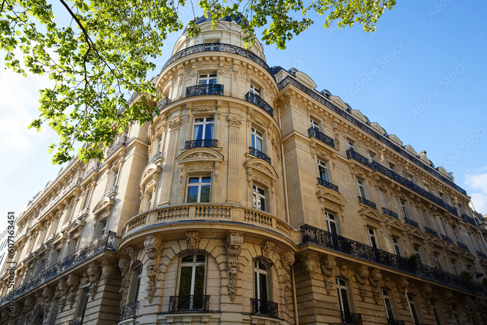 Fototapeta premium The facade of traditional French house with typical balconies and windows. Paris.