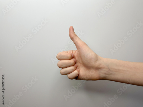 the hand gesture is a big paley up, expressing success on a light background
