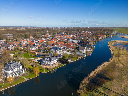 Aerial drone photo of luxury houses next to a river in Warmond