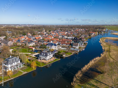 Aerial drone photo of luxury houses next to a river in Warmond © robin