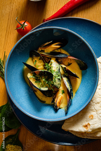 Delicious asian style steamed mussels with flatbread and sauce photo