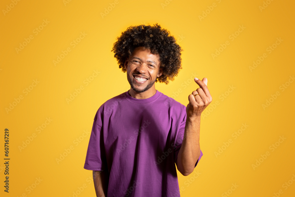 Glad confident mature black curly man in violet t-shirt snaps fingers gesture Glad confident mature black curly man in violet t-shirt snaps fingers gesture