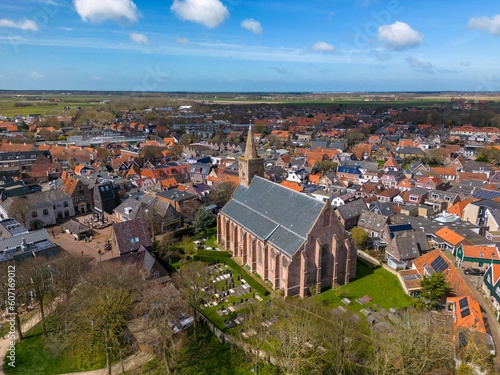 This aerial drone photo shows the old city center of Den Burg with a beautiful church. Den Burg is the capital of Texel, an island in the Wadden Sea, the Netherlands.  photo