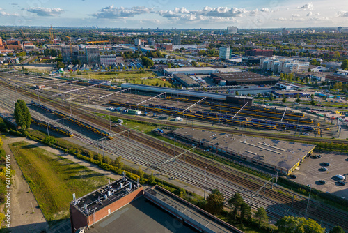 This aerial drone photo shows a marshalling yard in Den Haag, the Netherlands. There are many railway tracks and trains. 