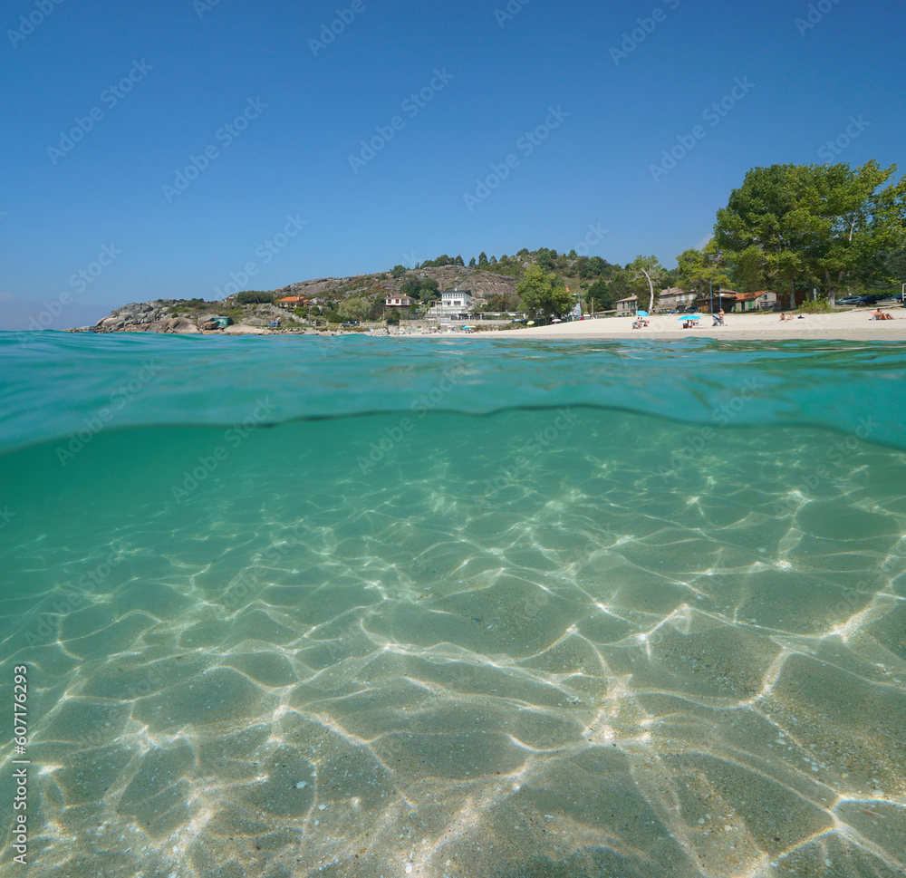 Atlantic coast beach with sand underwater in Spain, Galicia, split level view over and under water surface, Rias Baixas, Aldan, Cangas de Morrazo