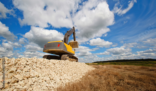 Excavator unload gravel. An...