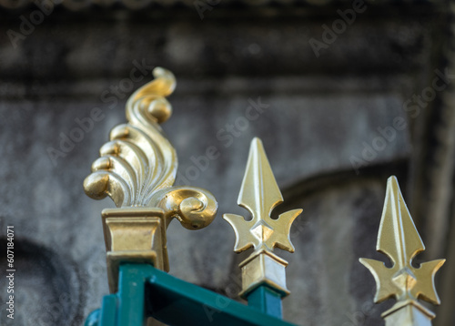 Closeup of an Antique Gold Tipped Teal Metal Fence.