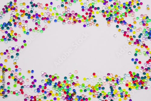 Multicolored tiny faceted crystals on a white background, beautiful colorful texture