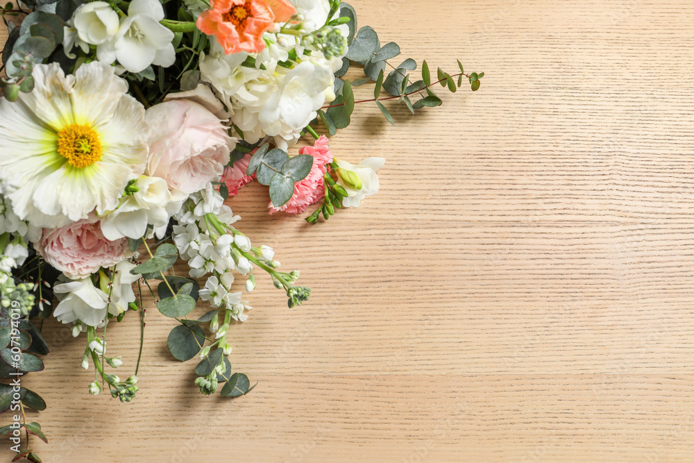 Bouquet of beautiful flowers on wooden table, above view. Space for text Bouquet of beautiful flowers on wooden table, above view. Space for text