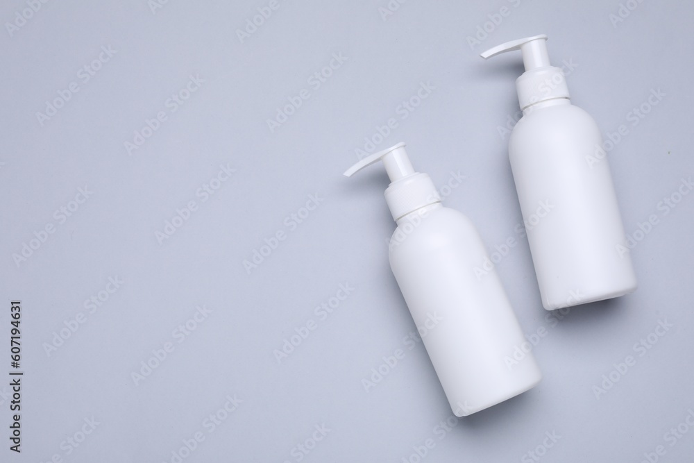 Different cleansers on light grey background, flat lay and space for text. Cosmetic product Different cleansers on light grey background, flat lay and space for text. Cosmetic product