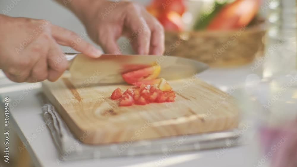 Cooking - Chef's hands are cutting tomatoes on the chopping board in the kitchen. Preparing pork stock with vegetables (broth) in a pot. Homemade bouillon recipe. Cooking - Chef's hands are cutting tomatoes on the chopping board in the kitchen. Preparing pork stock with vegetables (broth) in a pot. Homemade bouillon recipe.