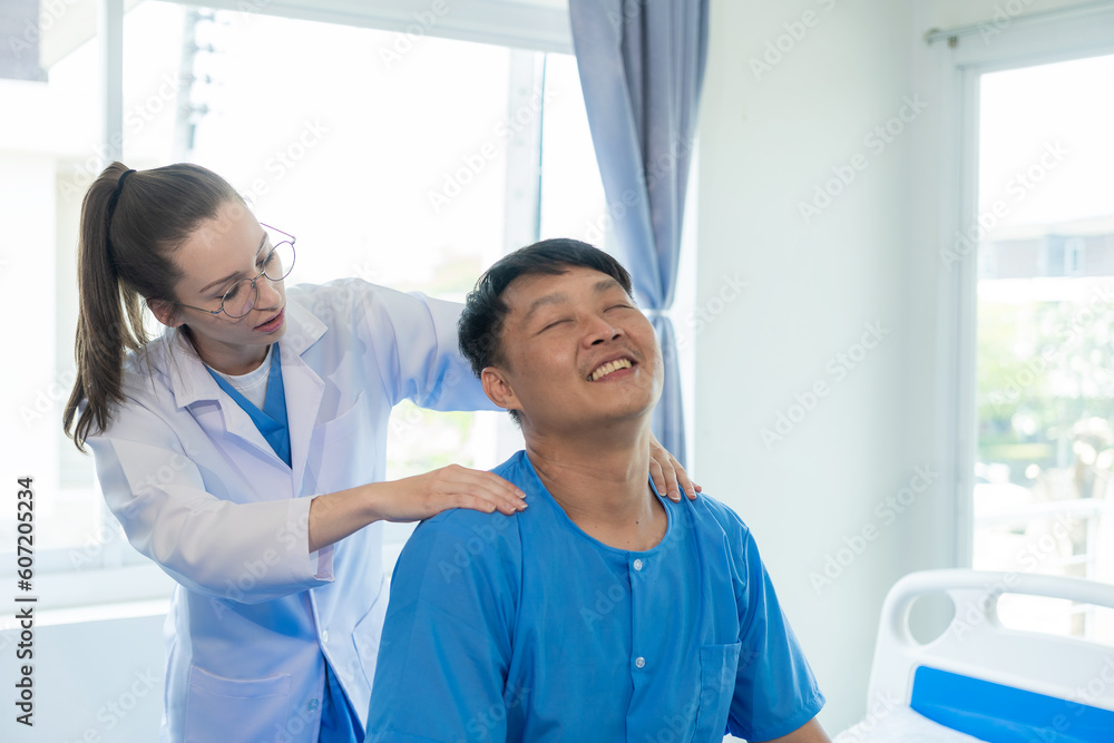 Obraz premium Female doctor's hand doing physiotherapy stretching the shoulder of a male patient. Doctor or physiotherapist working on male patient's limb muscle injury in clinic