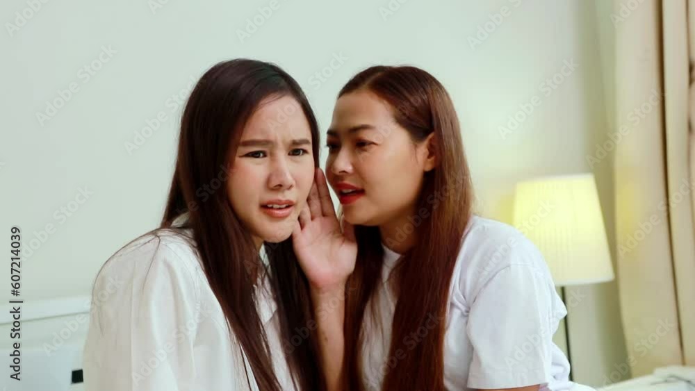 Gossip before bed in the bedroom at home : Intimate female friends sit and chat about secrets, gossip, talk about slander to another friend in order to believe in negative stories. Gossip before bed in the bedroom at home : Intimate female friends sit and chat about secrets, gossip, talk about slander to another friend in order to believe in negative stories.