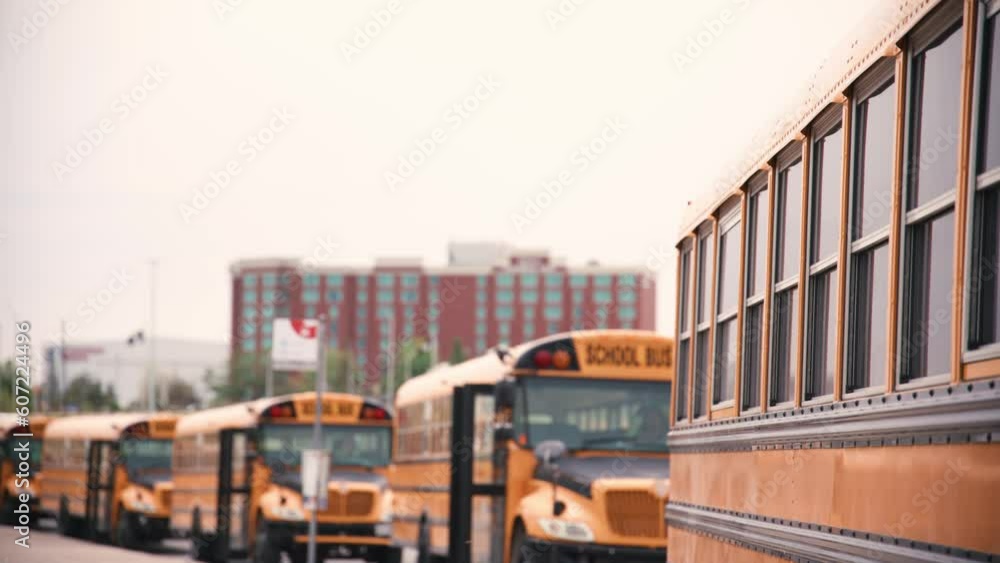 Tilt down reveal a line up of school busses Tilt down reveal a line up of school busses