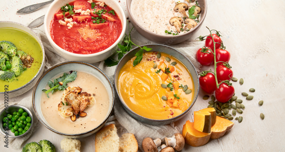 Composition with various soups, ingredients and space for text on white background. Healthy food. Composition with various soups, ingredients and space for text on white background. Healthy food.