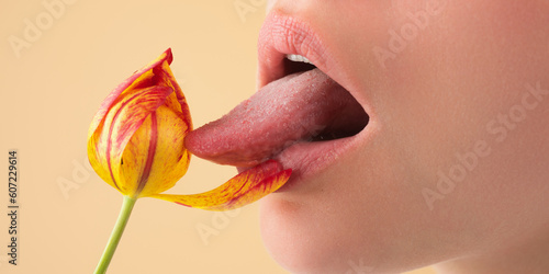 Licking lips. Woman mouth with sexy lips licking tongue flower. Mouth lick and suck close up. Beauty natural lips. Sensual licking, open sexy mouth. Sexy lick with tongue concept. Girl licking tulip.