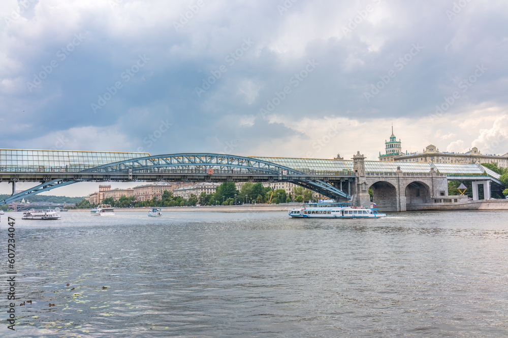 View of the Moscow river embakment, Pushkinsky bridge and cruise ships at sunset. View of the Moscow river embakment, Pushkinsky bridge and cruise ships at sunset.