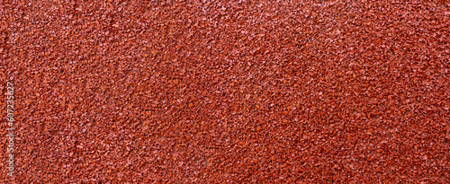 Close up of red rubber floor background. rubber flooring for sports and playgrounds, Running racetrack, tennis court.