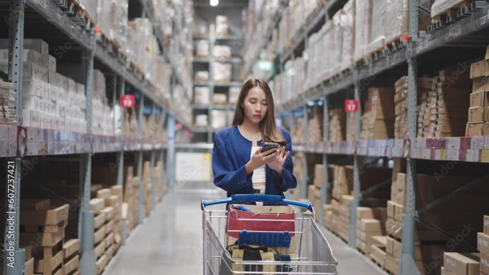 Asian woman using telephone looking up stock taking inventory in warehouse shopping. logistic industry and business import export. Asian woman using telephone looking up stock taking inventory in warehouse shopping. logistic industry and business import export.